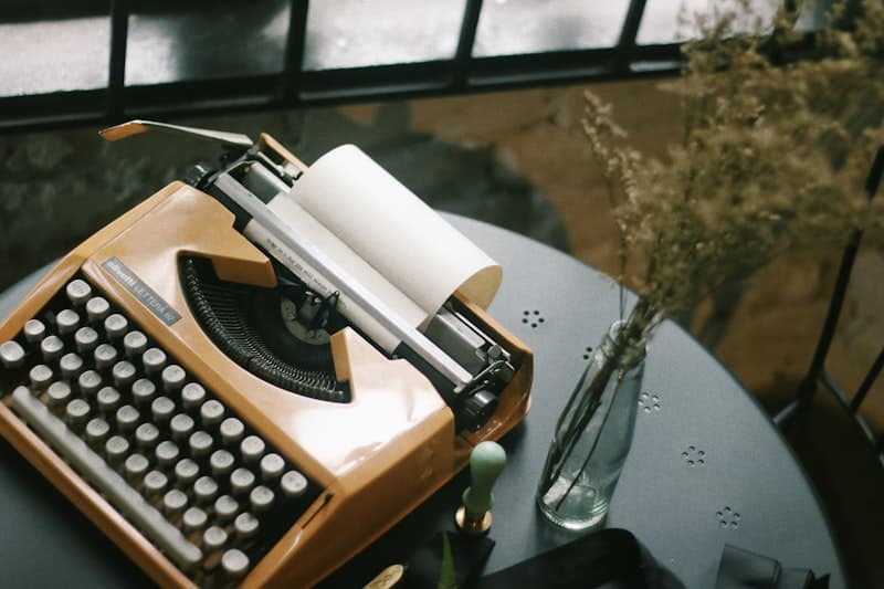 A typewriter and paper on an outdoor table